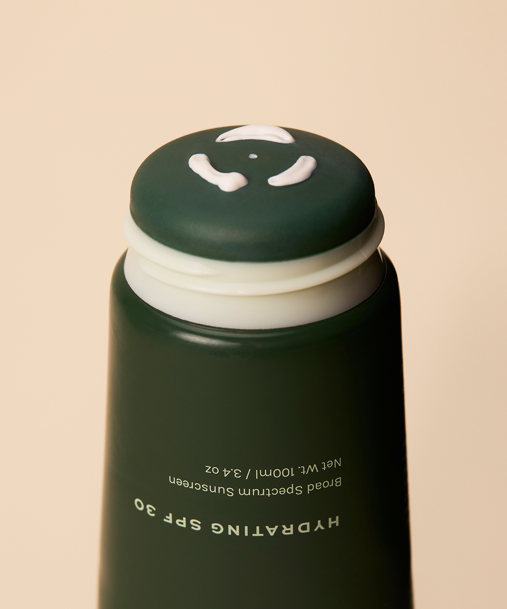 Close up of Practical Alchemy Hydrating SPF 30 sunscreen being pushed through onto application surface