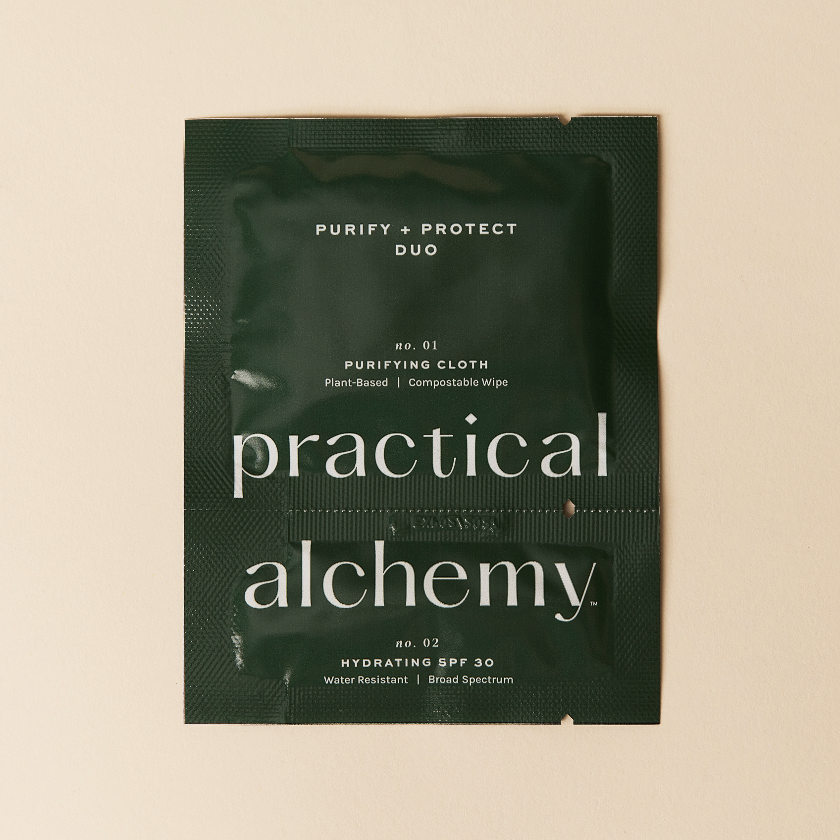 Green sachet of Practical Alchemy Purify + Protect Duo on a beige background