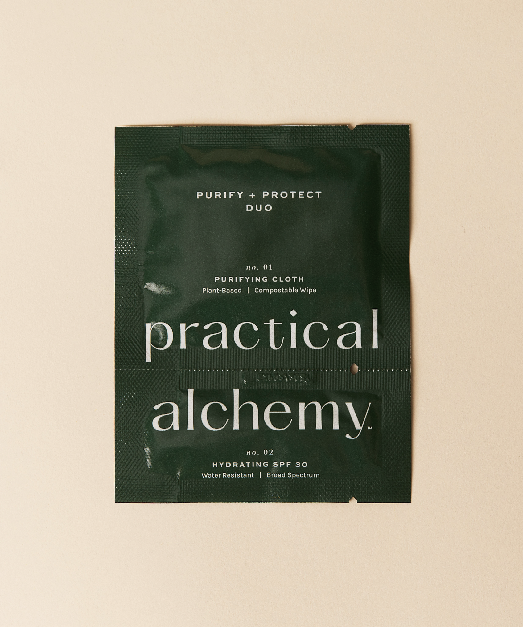 Green sachet of Practical Alchemy Purify + Protect Duo on a beige background