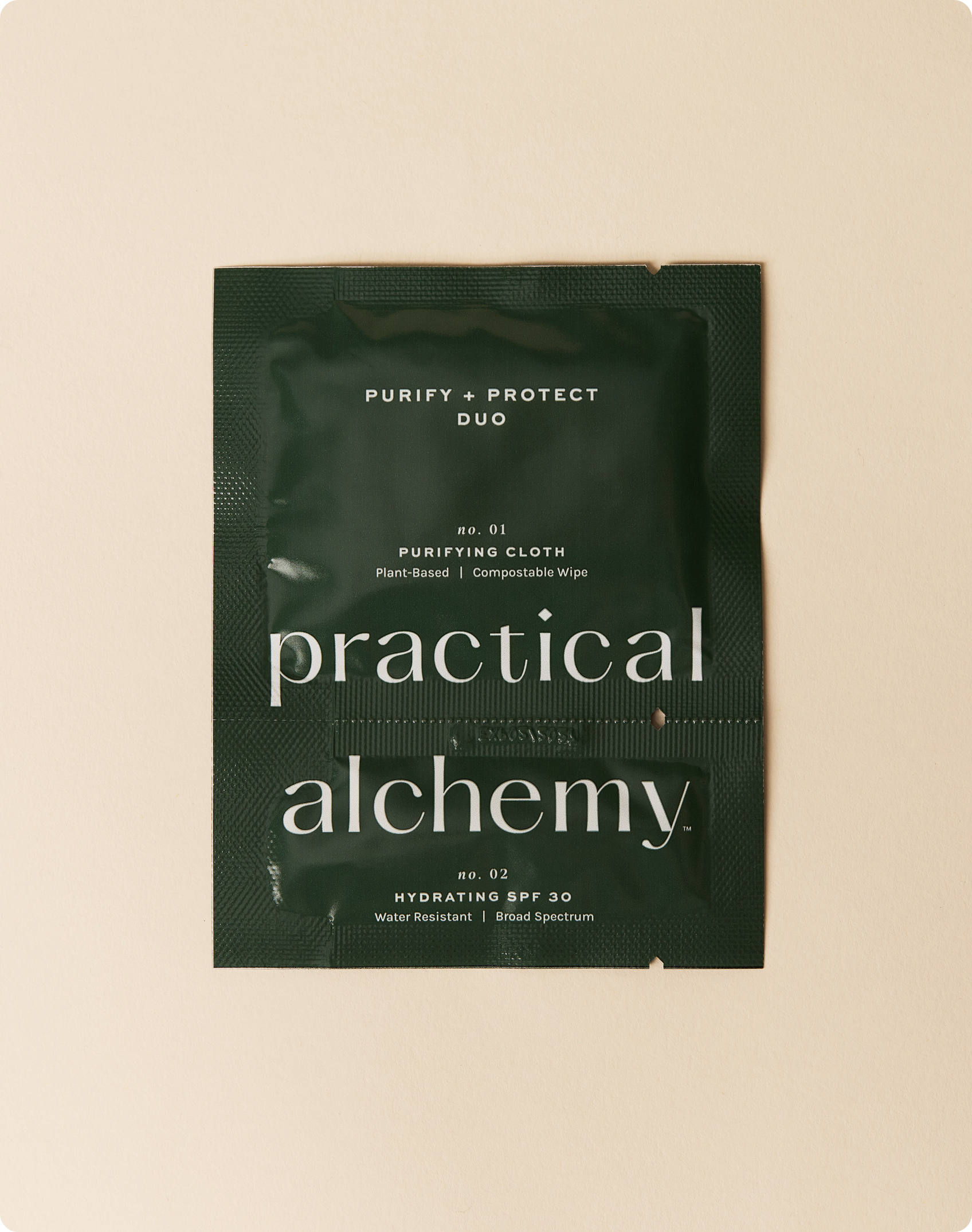 Green sachet of Practical Alchemy Purify + Protect Duo on a beige background