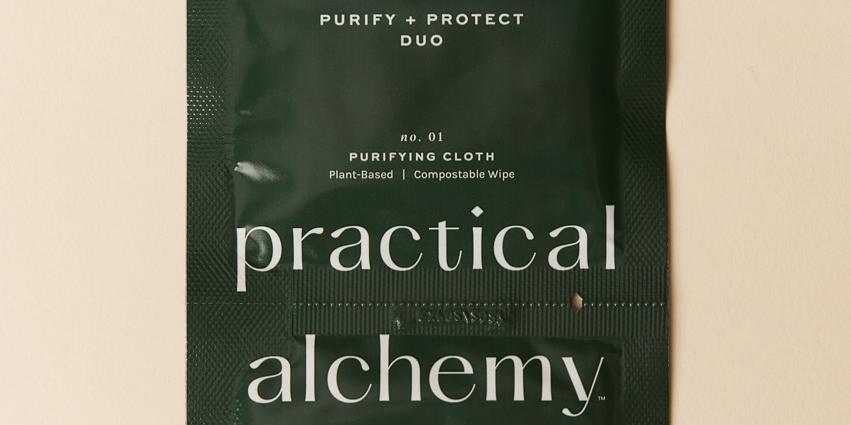 Green sachet of Practical Alchemy Purify + Protect Duo on a beige background