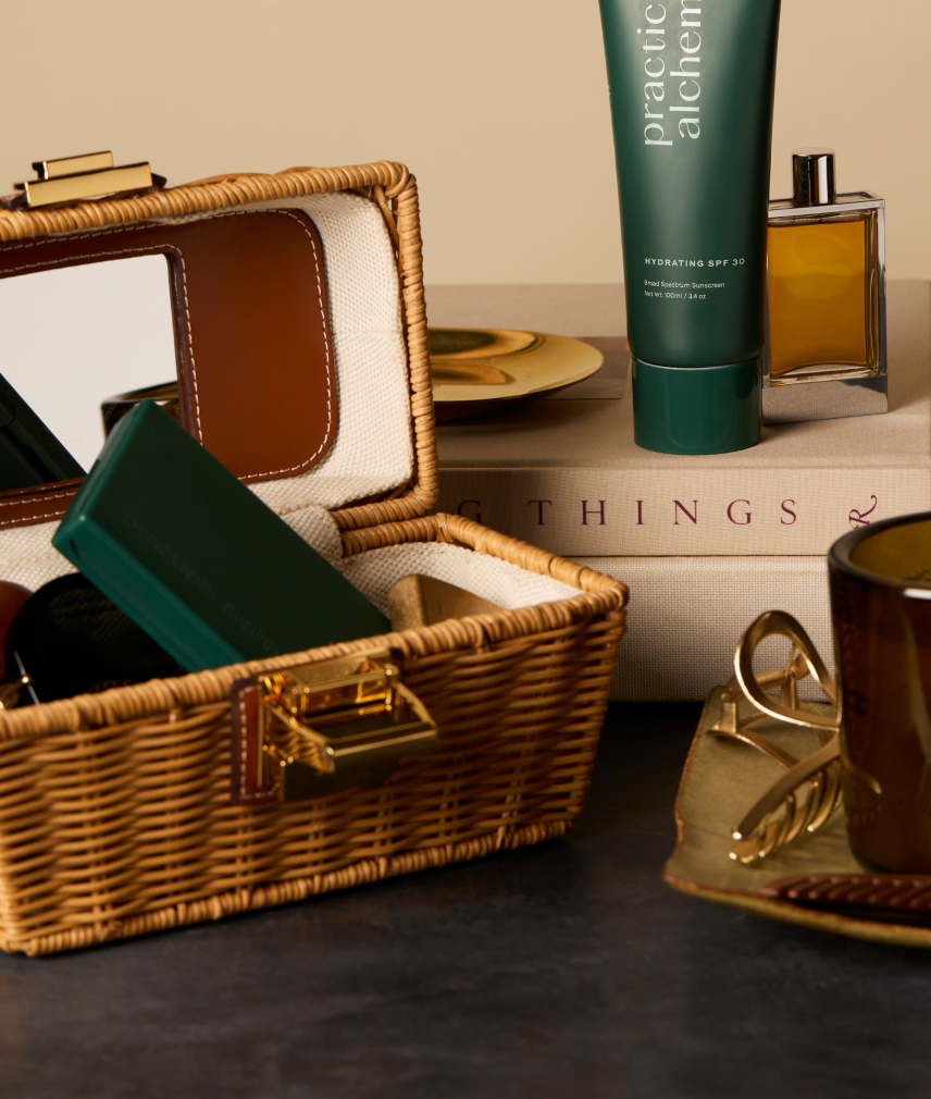 Wicker basket with beauty products on a table including Just in Case carrying case and Hydrating SPF 30