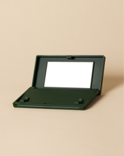 green Just in Case vanishing pimple patch carrying case on beige background