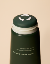 Close up of Practical Alchemy Hydrating SPF 30 sunscreen being pushed through onto application surface