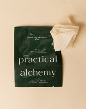 Green package of Purify + Protect Duo sachet with a beige micellar water cloth on a beige background